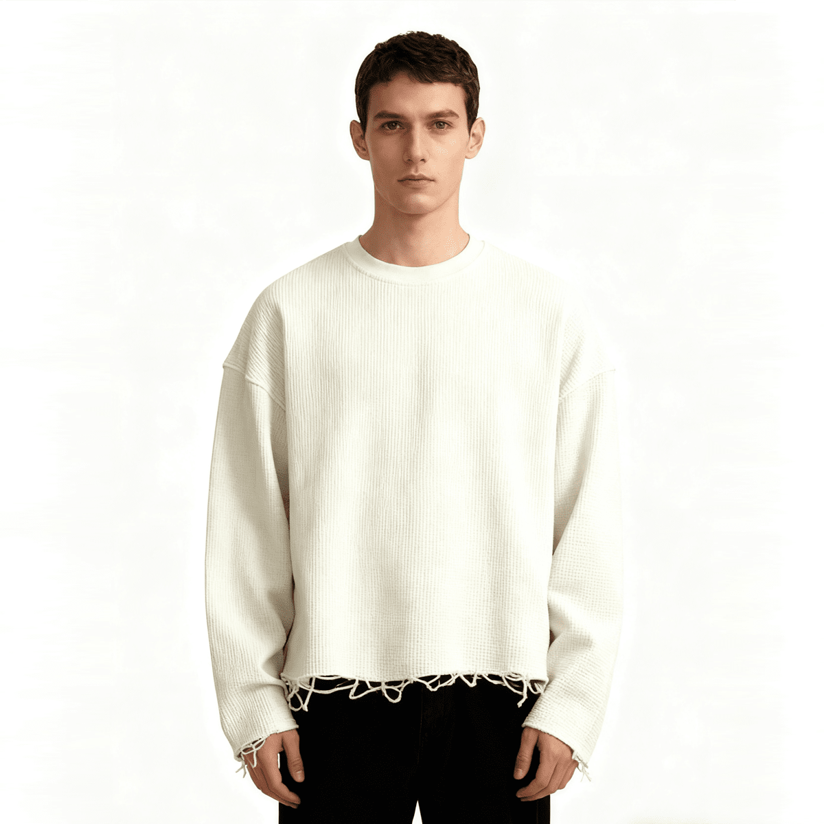 Man wearing a white sweater with a plain background